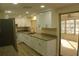 Modern kitchen featuring white cabinets, granite countertops, and stainless steel appliances at 3518 Moog Rd, Holiday, FL 34691