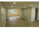 Open living room with wood-look floors and access to dining area at 3518 Moog Rd, Holiday, FL 34691
