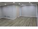Bright living room with wood-look floors and recessed lighting at 3518 Moog Rd, Holiday, FL 34691