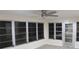 Sunroom with multiple windows and ceiling fan at 3518 Moog Rd, Holiday, FL 34691