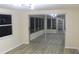 Sunroom with mirrored sliding doors and wood-look floors at 3518 Moog Rd, Holiday, FL 34691