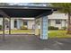 Carport with view of house and landscaped area at 4231 Richmere Dr # 3D, New Port Richey, FL 34652