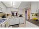 White kitchen with granite countertops and stainless steel appliances at 4231 Richmere Dr # 3D, New Port Richey, FL 34652