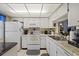 Well-equipped kitchen with white cabinets and granite counters at 4231 Richmere Dr # 3D, New Port Richey, FL 34652