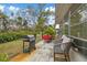 Relaxing patio with seating and grill, overlooking backyard at 4231 Richmere Dr # 3D, New Port Richey, FL 34652