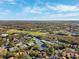 Aerial view of community with tennis courts, golf course, and residential buildings at 4886 Westchester Ct, Oldsmar, FL 34677