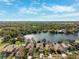 Aerial view highlights lakefront properties with pristine landscaping in a gated community at 4886 Westchester Ct, Oldsmar, FL 34677