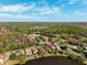 Drone shot of homes near a golf course and a lake surrounded by a community at 4886 Westchester Ct, Oldsmar, FL 34677