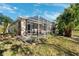 Backyard featuring a screened in patio with outdoor furniture and plush landscaping at 4886 Westchester Ct, Oldsmar, FL 34677
