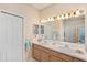 Traditional bathroom features double sinks and a large vanity mirror at 4886 Westchester Ct, Oldsmar, FL 34677