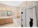 Full bathroom with a vanity, garden tub, and a glass-enclosed shower at 4886 Westchester Ct, Oldsmar, FL 34677