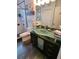 Modern bathroom with a unique green glass sink, updated fixtures, and a glass enclosed shower at 4886 Westchester Ct, Oldsmar, FL 34677