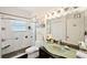 Bright bathroom featuring modern glass shower, updated fixtures, and a unique green glass sink at 4886 Westchester Ct, Oldsmar, FL 34677