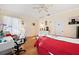 Bright bedroom with a queen bed, a desk and chair, and ample closet space at 4886 Westchester Ct, Oldsmar, FL 34677