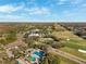 An aerial view of a community with a golf course and community pool at 4886 Westchester Ct, Oldsmar, FL 34677