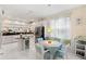 Bright kitchen with white cabinets, stainless steel appliances, and adjacent breakfast nook at 4886 Westchester Ct, Oldsmar, FL 34677