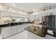 Bright kitchen featuring white cabinetry, dark countertops, and stainless steel appliances, offering a modern and functional space at 4886 Westchester Ct, Oldsmar, FL 34677