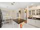 Bright kitchen featuring white cabinetry, dark countertops, and stainless steel appliances, offering a modern and functional space at 4886 Westchester Ct, Oldsmar, FL 34677