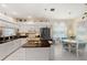 Bright kitchen featuring white cabinetry, dark countertops, stainless steel appliances, and an adjacent breakfast nook at 4886 Westchester Ct, Oldsmar, FL 34677