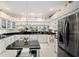 Bright kitchen featuring white cabinetry, dark countertops, and stainless steel appliances, offering a modern and functional space at 4886 Westchester Ct, Oldsmar, FL 34677