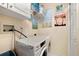 Laundry room with washer, dryer, storage and decorative art at 4886 Westchester Ct, Oldsmar, FL 34677