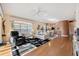 Open concept living area with hardwood floors, and a view of the kitchen at 4886 Westchester Ct, Oldsmar, FL 34677