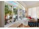 Bright sitting area with a desk overlooking an outside patio with a water view at 4886 Westchester Ct, Oldsmar, FL 34677