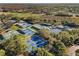 An aerial view of tennis courts in a community with a golf course nearby at 4886 Westchester Ct, Oldsmar, FL 34677