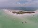 Aerial view of waterfront property with boats and clear water at 5102 Blue Heron Dr, New Port Richey, FL 34652