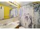 Clean bathroom with a mermaid-themed shower curtain at 5102 Blue Heron Dr, New Port Richey, FL 34652