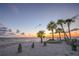 Scenic sunset over calm ocean with palm trees at 5102 Blue Heron Dr, New Port Richey, FL 34652