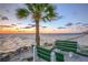Tranquil beach setting at sunset with benches at 5102 Blue Heron Dr, New Port Richey, FL 34652