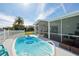 Relaxing pool with a screened enclosure and lounge chairs at 5102 Blue Heron Dr, New Port Richey, FL 34652