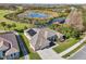 Aerial view of house, golf course, and pond at 7302 Melogold Cir, Land O Lakes, FL 34637