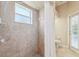 Bathroom with shower, toilet and exterior access at 7302 Melogold Cir, Land O Lakes, FL 34637