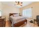 Bedroom with a double bed, ceiling fan, and window coverings at 7302 Melogold Cir, Land O Lakes, FL 34637