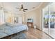 Spacious bedroom with pool access and a large TV at 7302 Melogold Cir, Land O Lakes, FL 34637