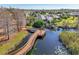 Community boardwalk over water with benches; serene waterfront views at 7302 Melogold Cir, Land O Lakes, FL 34637