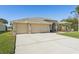 Three-car garage and attractive landscaping enhance this home's curb appeal at 7302 Melogold Cir, Land O Lakes, FL 34637