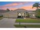 Attractive single-story home with three-car garage and landscaped yard at 7302 Melogold Cir, Land O Lakes, FL 34637