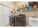 Laundry room with washer, dryer, and ample storage shelving at 7302 Melogold Cir, Land O Lakes, FL 34637