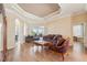 Spacious living room with hardwood floors, comfortable seating and high ceilings at 7302 Melogold Cir, Land O Lakes, FL 34637