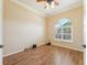 Bright home office featuring wood flooring and an arched window at 7302 Melogold Cir, Land O Lakes, FL 34637