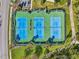 Four tennis courts with ample space for players at 7302 Melogold Cir, Land O Lakes, FL 34637