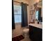 Clean bathroom with dark vanity, shower/tub combo, and decorative accents at 8278 Silverbell Loop, Brooksville, FL 34613