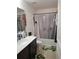 Simple bathroom with a tub shower, vanity, and a white toilet at 8278 Silverbell Loop, Brooksville, FL 34613