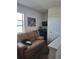 Cozy bonus room features a brown couch and a flat-screen TV at 8278 Silverbell Loop, Brooksville, FL 34613