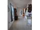 Bright entryway with tile flooring, coat rack, and a console table at 8278 Silverbell Loop, Brooksville, FL 34613