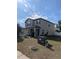Two-story house with a tan exterior, landscaping, and a two-car garage at 8278 Silverbell Loop, Brooksville, FL 34613