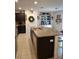 Modern kitchen with dark cabinets, granite countertops, and a large island at 8278 Silverbell Loop, Brooksville, FL 34613